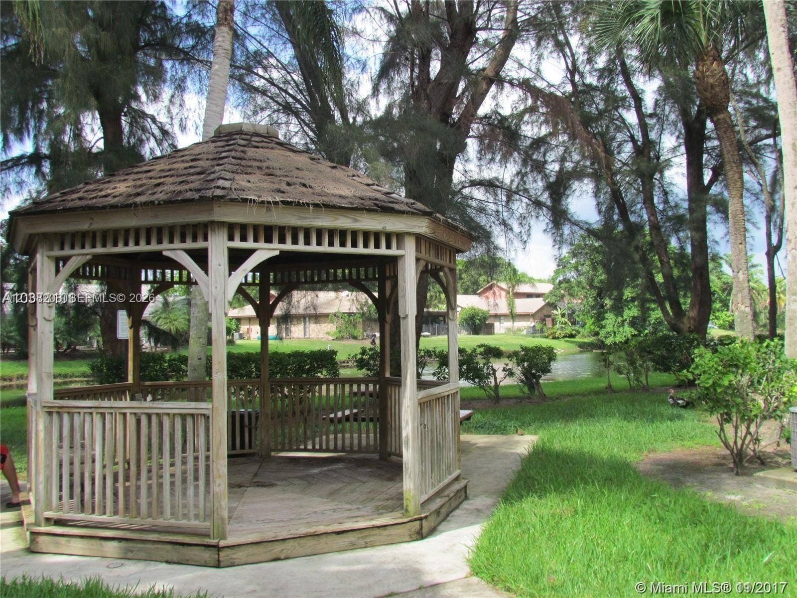 Coral Springs, Coral Springs, FL 33071 Octagonal wood gazebo featuring shingle roofing, lattice detailing, and a raised wooden deck