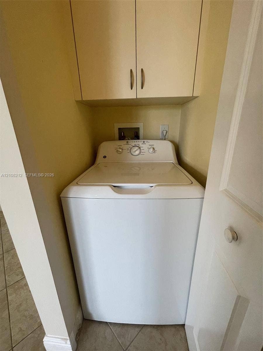 Sunrise, FL 33323 Built-in laundry alcove featuring overhead storage cabinetry and tiled flooring