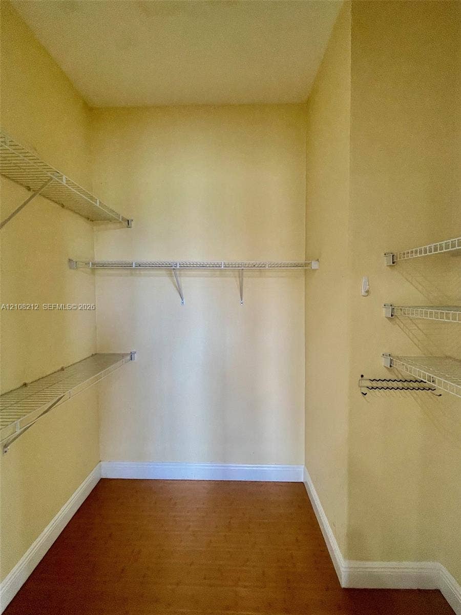 Sunrise, FL 33323 Walk-in storage space featuring wood-finish flooring and multiple tiers of wire shelving
