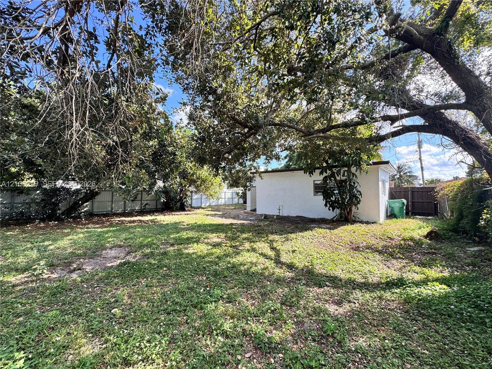 2381 NW 153rd Street, #2353, Miami Gardens, Miami Gardens, FL 33054 Backyard featuring a grass lawn, mature trees, and perimeter fencing