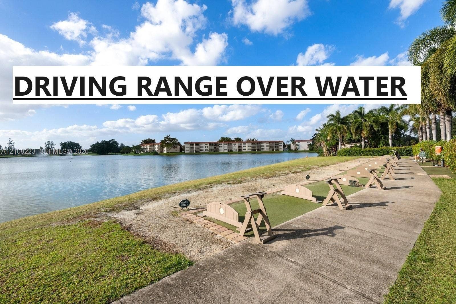 311 S Hollybrook Drive, #309, Pembroke Pines, FL 33025 Golf driving range featuring synthetic turf hitting stations, brick edging, concrete walkway, and water feature