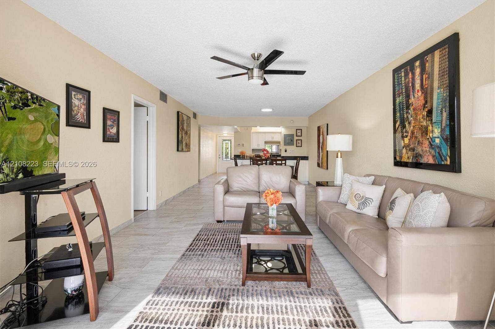 311 S Hollybrook Drive, #309, Pembroke Pines, FL 33025 Open-concept interior featuring light-toned tile flooring and a ceiling-mounted fan with integrated lighting