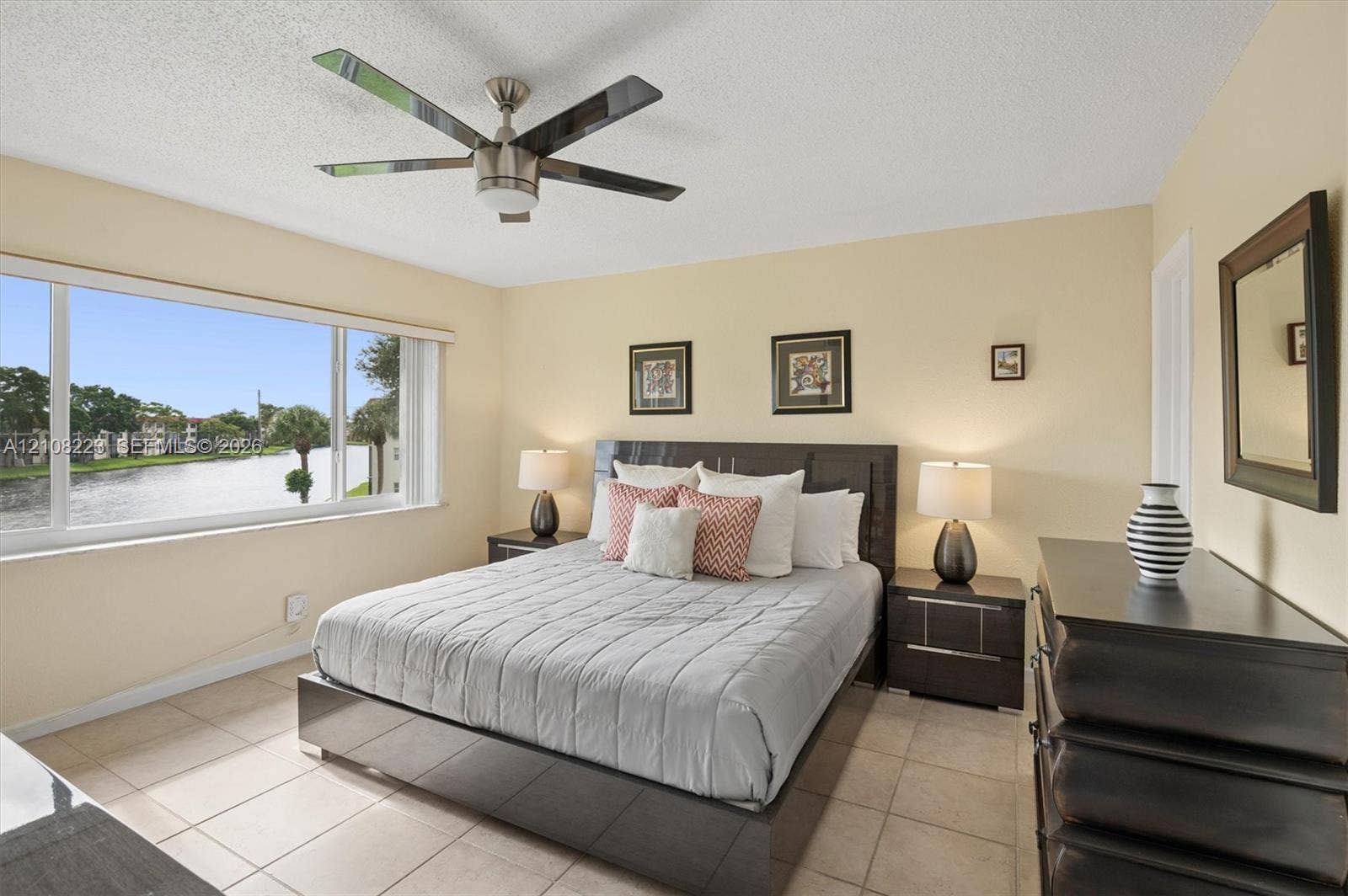 311 S Hollybrook Drive, #309, Pembroke Pines, FL 33025 Large window with water scenery, tile flooring, and a ceiling fan with integrated lighting
