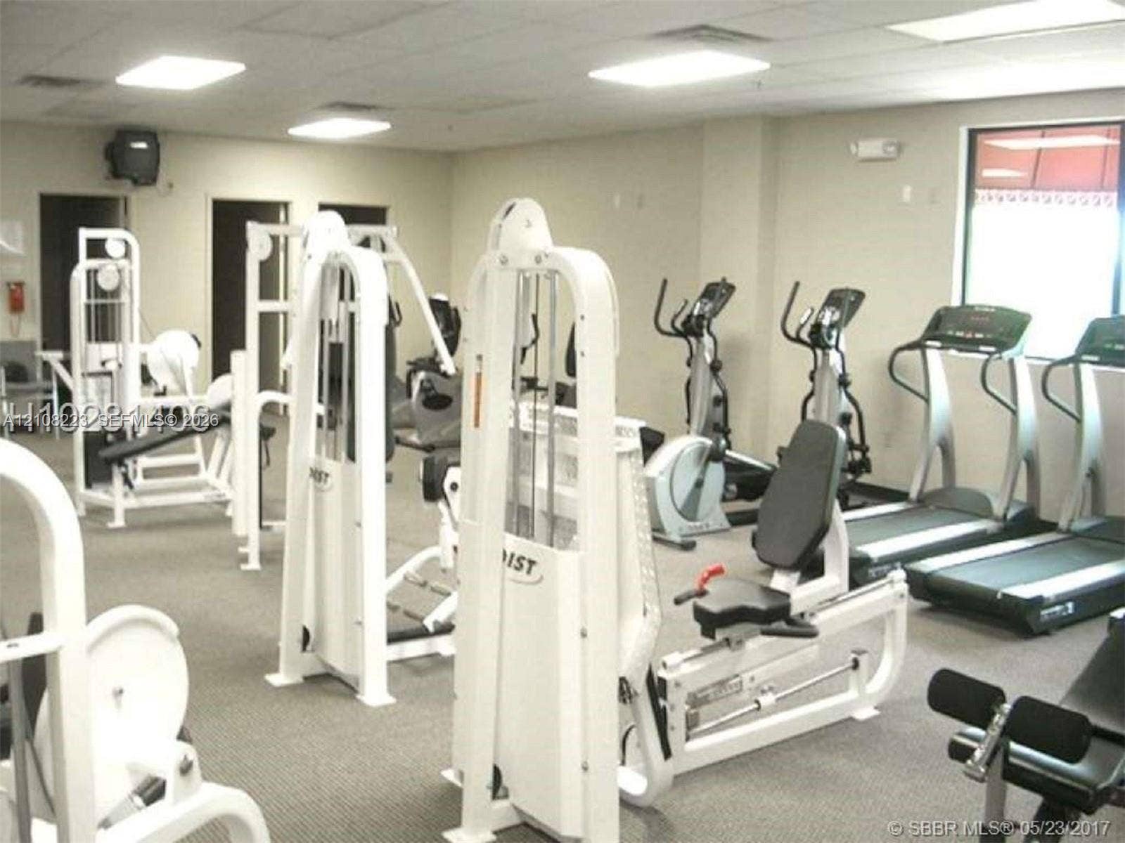 311 S Hollybrook Drive, #309, Pembroke Pines, FL 33025 Fitness facility featuring neutral carpeting, recessed ceiling lighting, and multiple large windows