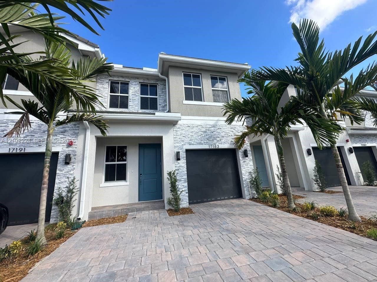 17183 SW 2nd Circle, #17183, Pembroke Pines, Pembroke Pines, FL 33027 Two-story exterior featuring a stone veneer facade, paver driveway, solid-color entry door, and attached garage