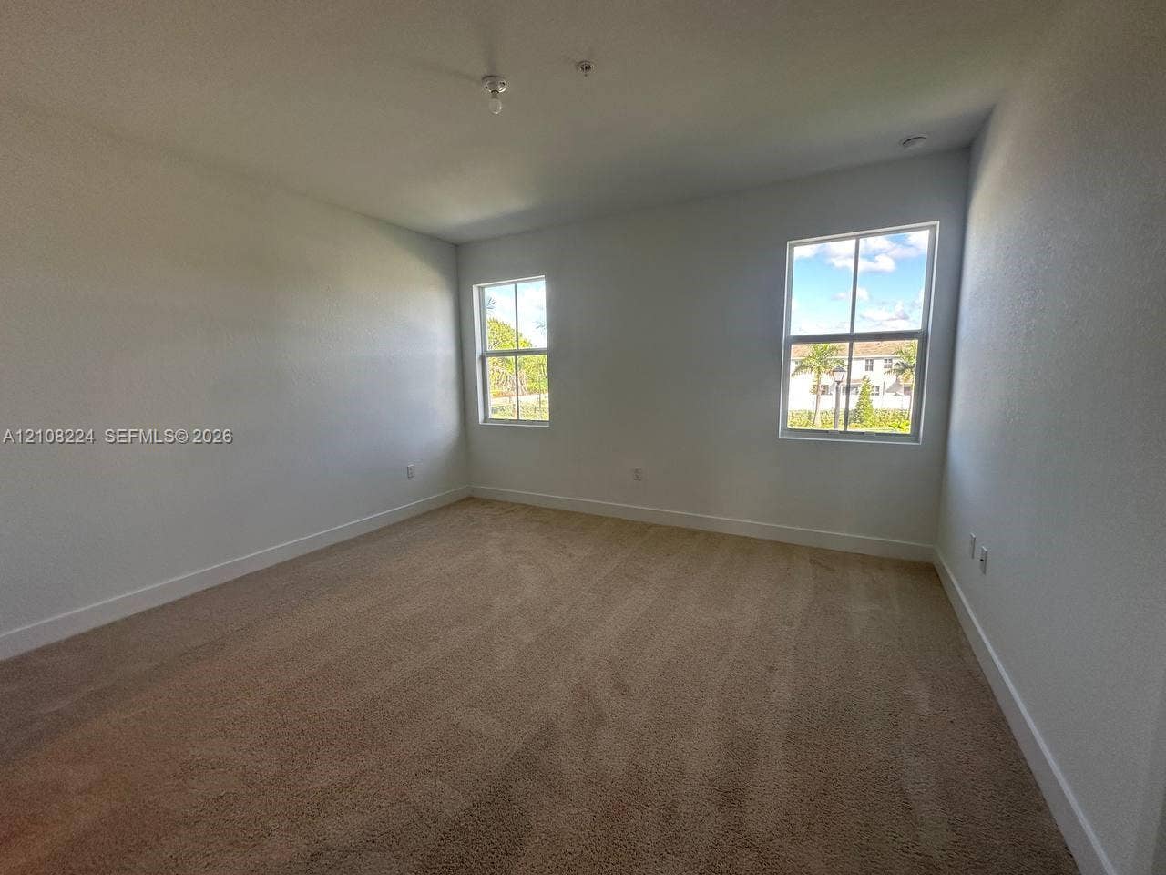 17183 SW 2nd Circle, #17183, Pembroke Pines, Pembroke Pines, FL 33027 Neutral interior room featuring plush carpeting and two multi-pane windows