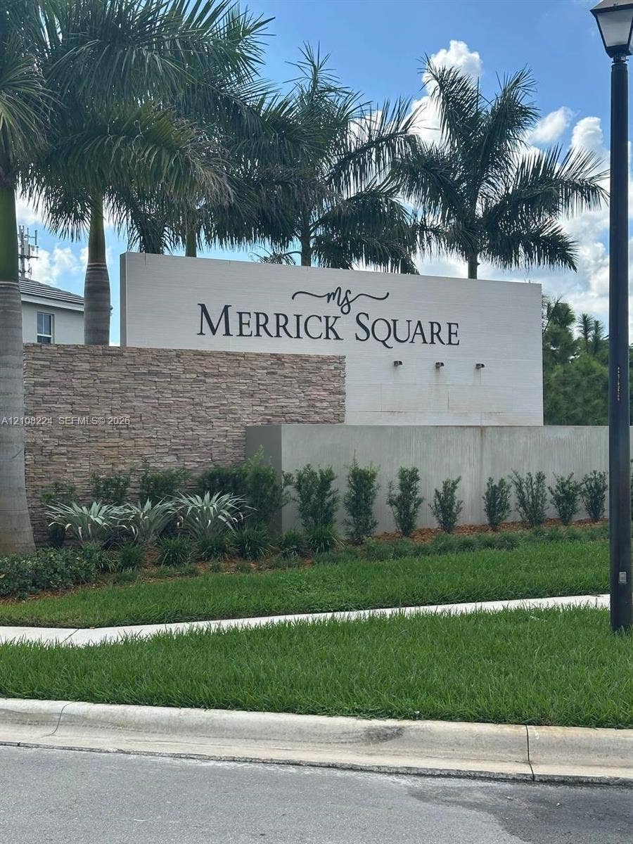 17183 SW 2nd Circle, #17183, Pembroke Pines, Pembroke Pines, FL 33027 Monument signage featuring stacked stone accents, smooth concrete walls, and mature palm landscaping