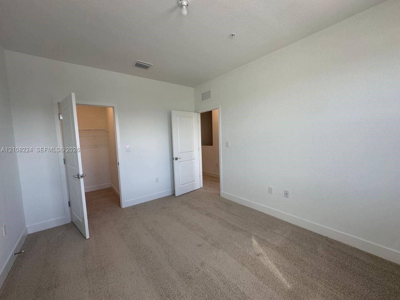 17183 SW 2nd Circle, #17183, Pembroke Pines, Pembroke Pines, FL 33027 Neutral-toned wall-to-wall carpeting, two interior panel doors, and built-in closet shelving