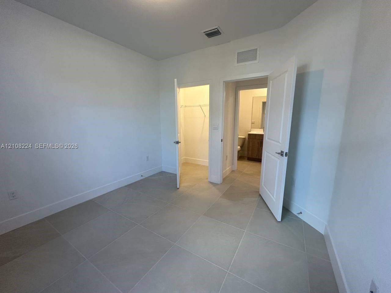17183 SW 2nd Circle, #17183, Pembroke Pines, Pembroke Pines, FL 33027 Neutral-toned large-format tile flooring, multi-panel doors, and walk-in closet space