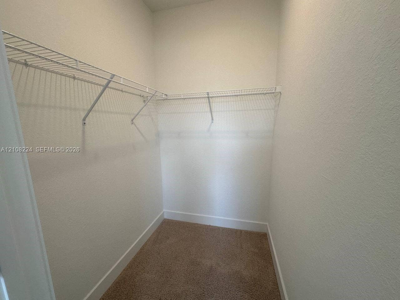 17183 SW 2nd Circle, #17183, Pembroke Pines, Pembroke Pines, FL 33027 Walk-in storage space featuring neutral carpeting and tiered white wire shelving