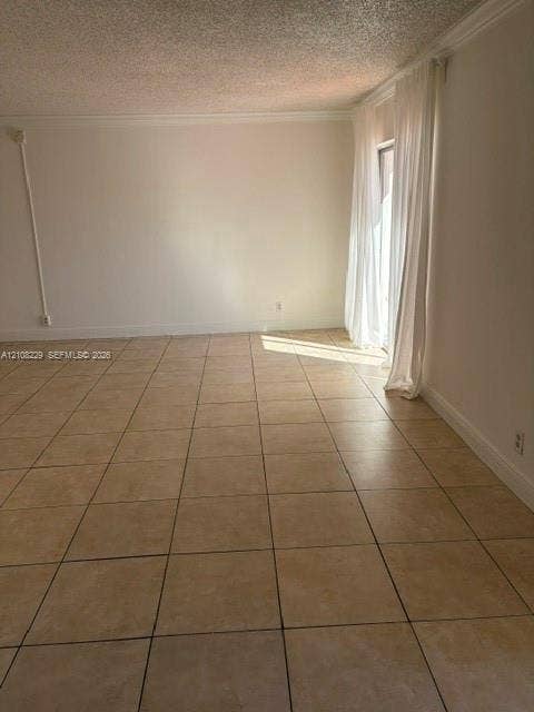 3200 Coral Springs Drive, Coral Springs, FL 33065 Room featuring neutral-toned tile flooring, textured ceiling finish, and a sliding glass door