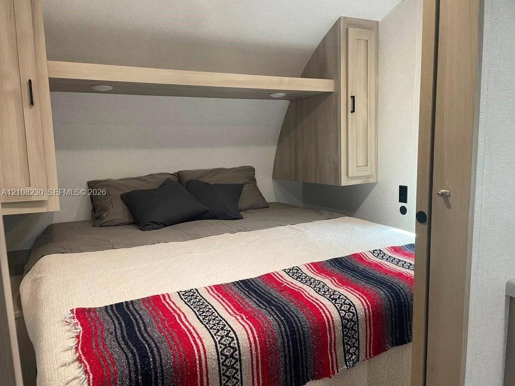 573 Mokena Drive, #1, Miami Springs, Miami Springs, FL 33166 Built-in cabinetry with light wood finish, integrated overhead shelving, and recessed lighting