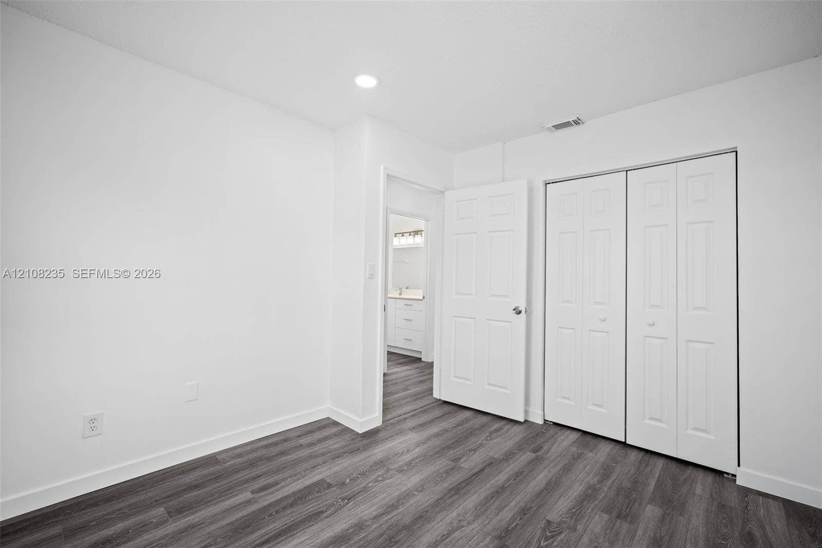 12752 SW 250th Terrace, Homestead, FL 33032 Wood-finish flooring, recessed lighting, and white bi-fold closet doors