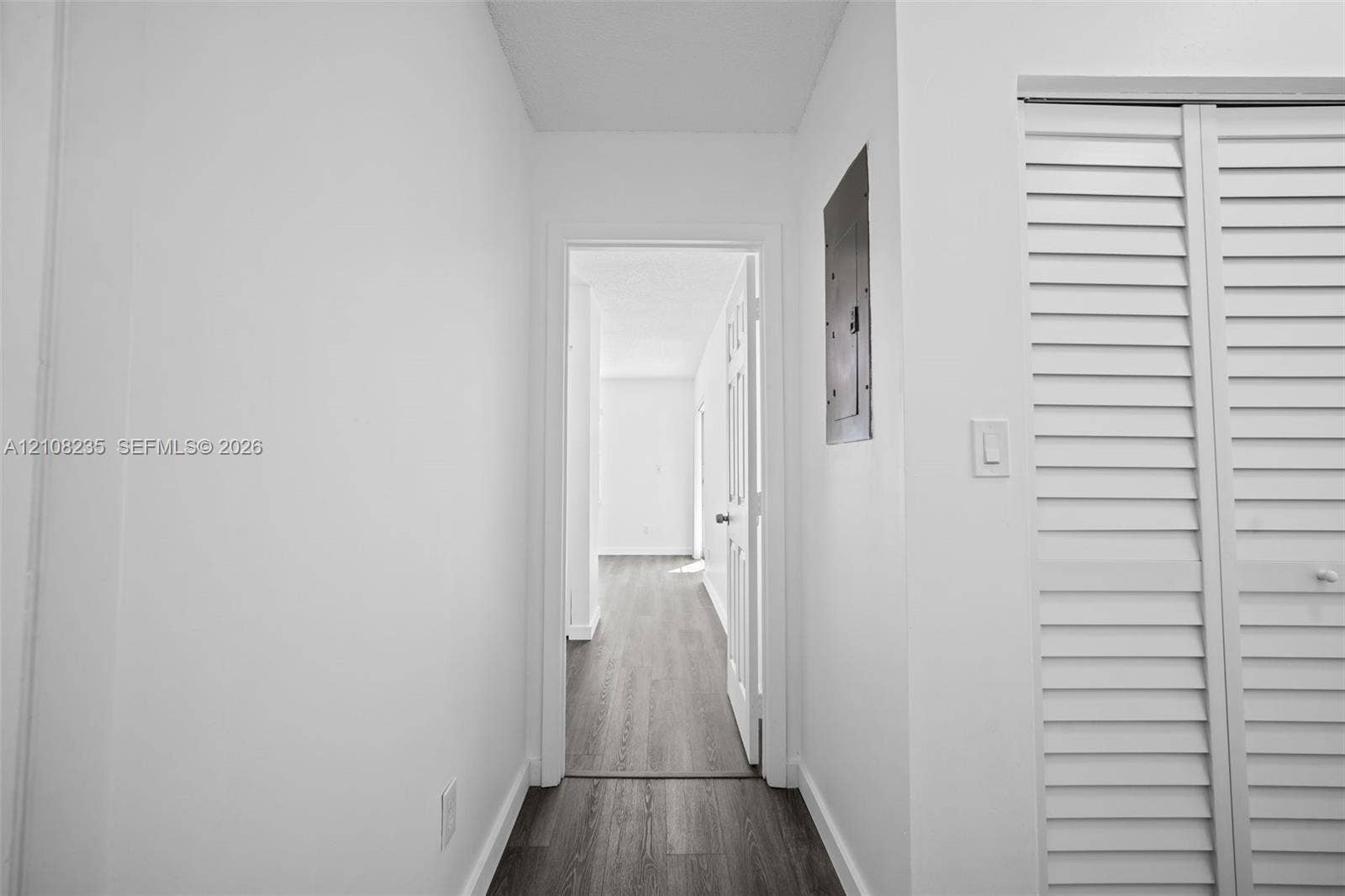 12752 SW 250th Terrace, Homestead, FL 33032 Wood-finish flooring, white walls, and bi-fold louvered closet doors