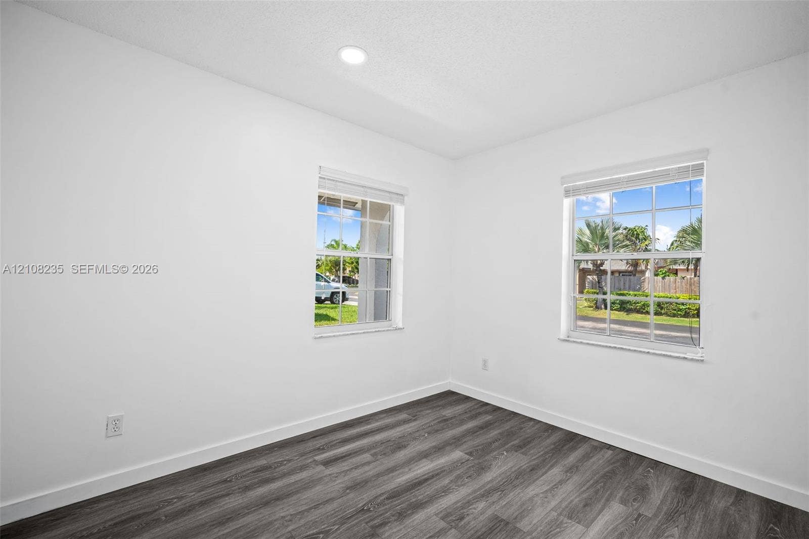 12752 SW 250th Terrace, Homestead, FL 33032 Interior room featuring neutral wall finishes, wood-finish flooring, two grid-pattern windows, and recessed lighting