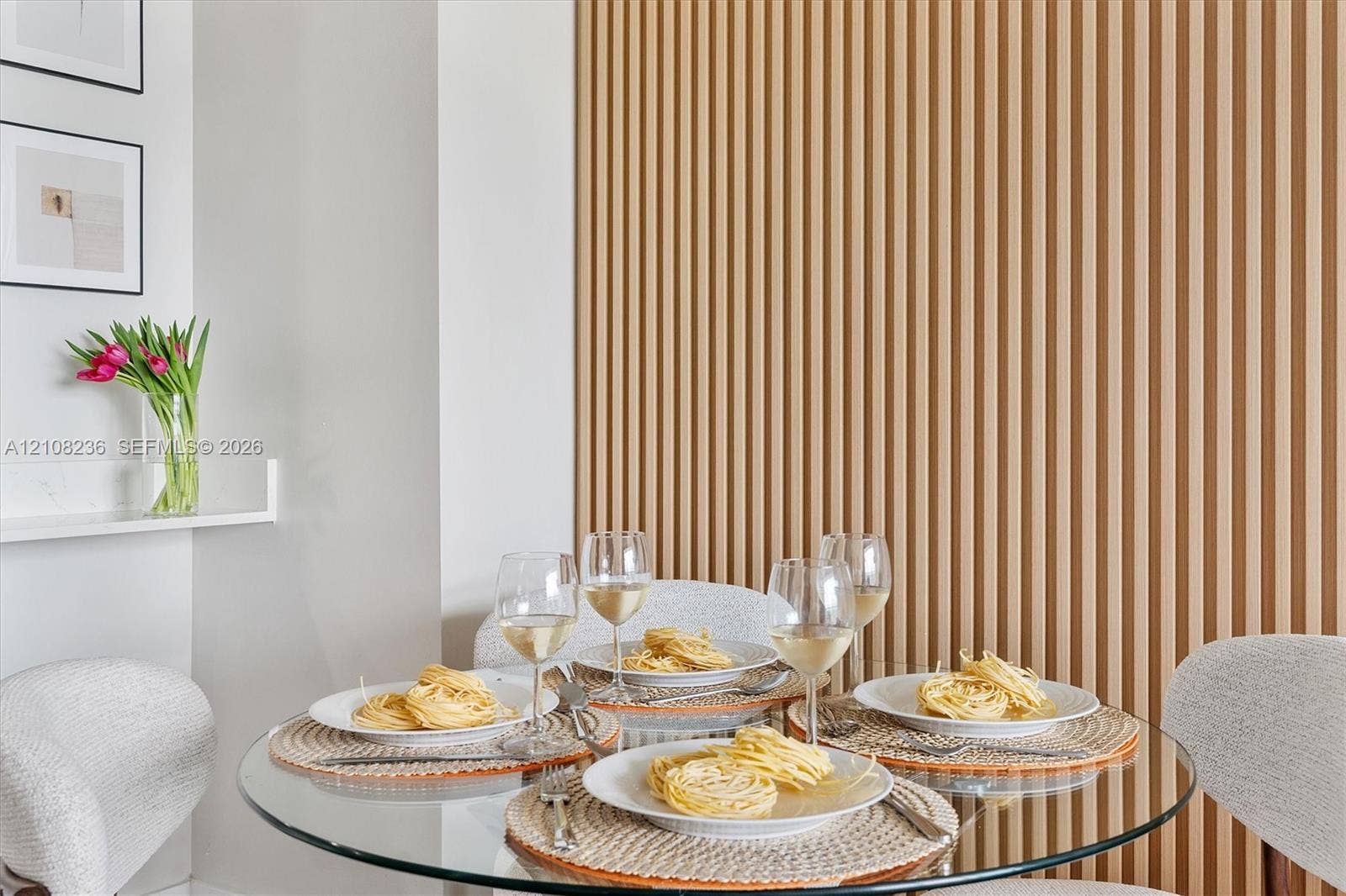 Vertical wood-slat accent wall with a matte finish and a built-in floating shelf