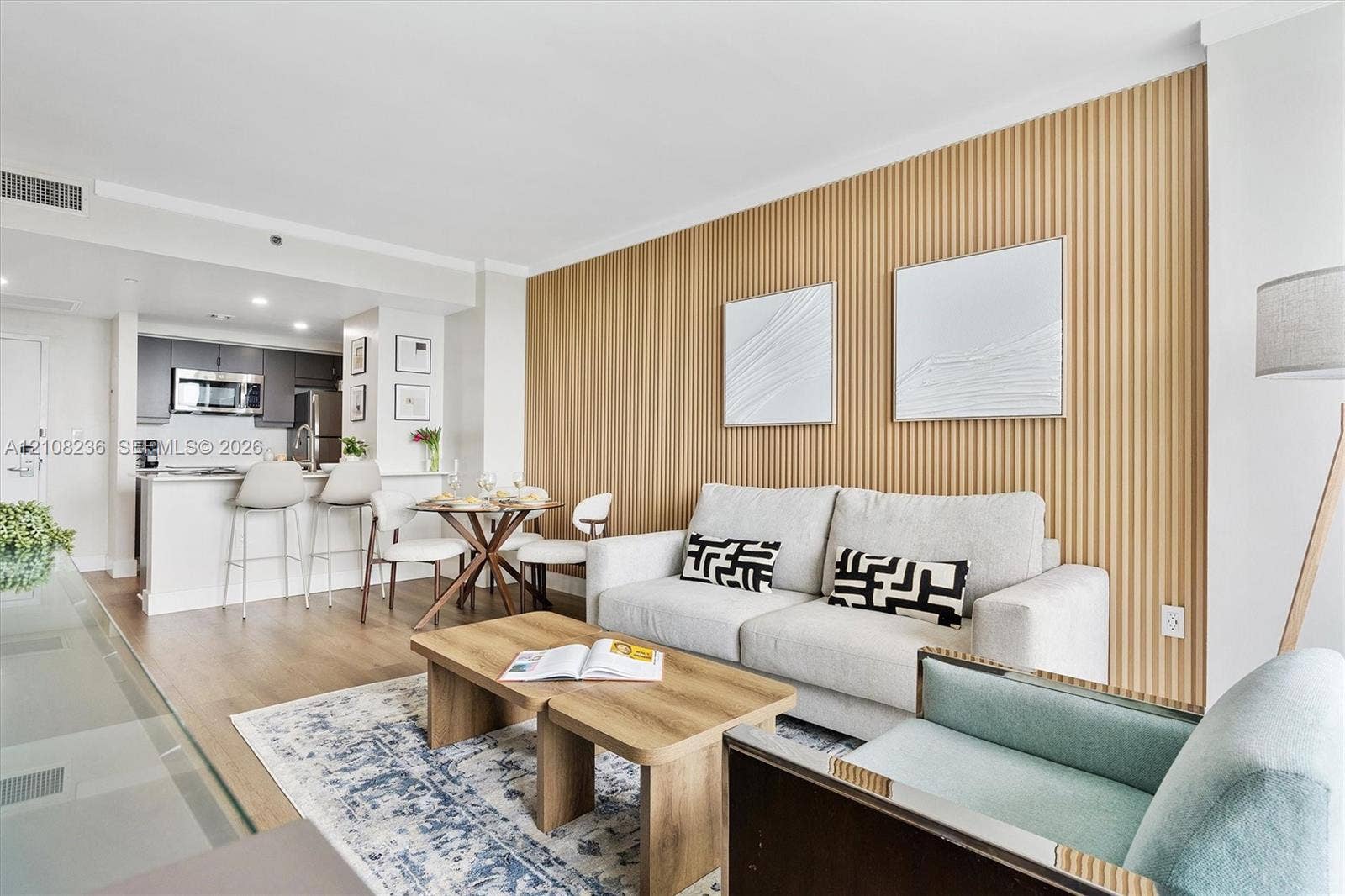 Vertical slat wood-finish accent wall, wood-finish flooring, and recessed ceiling lighting