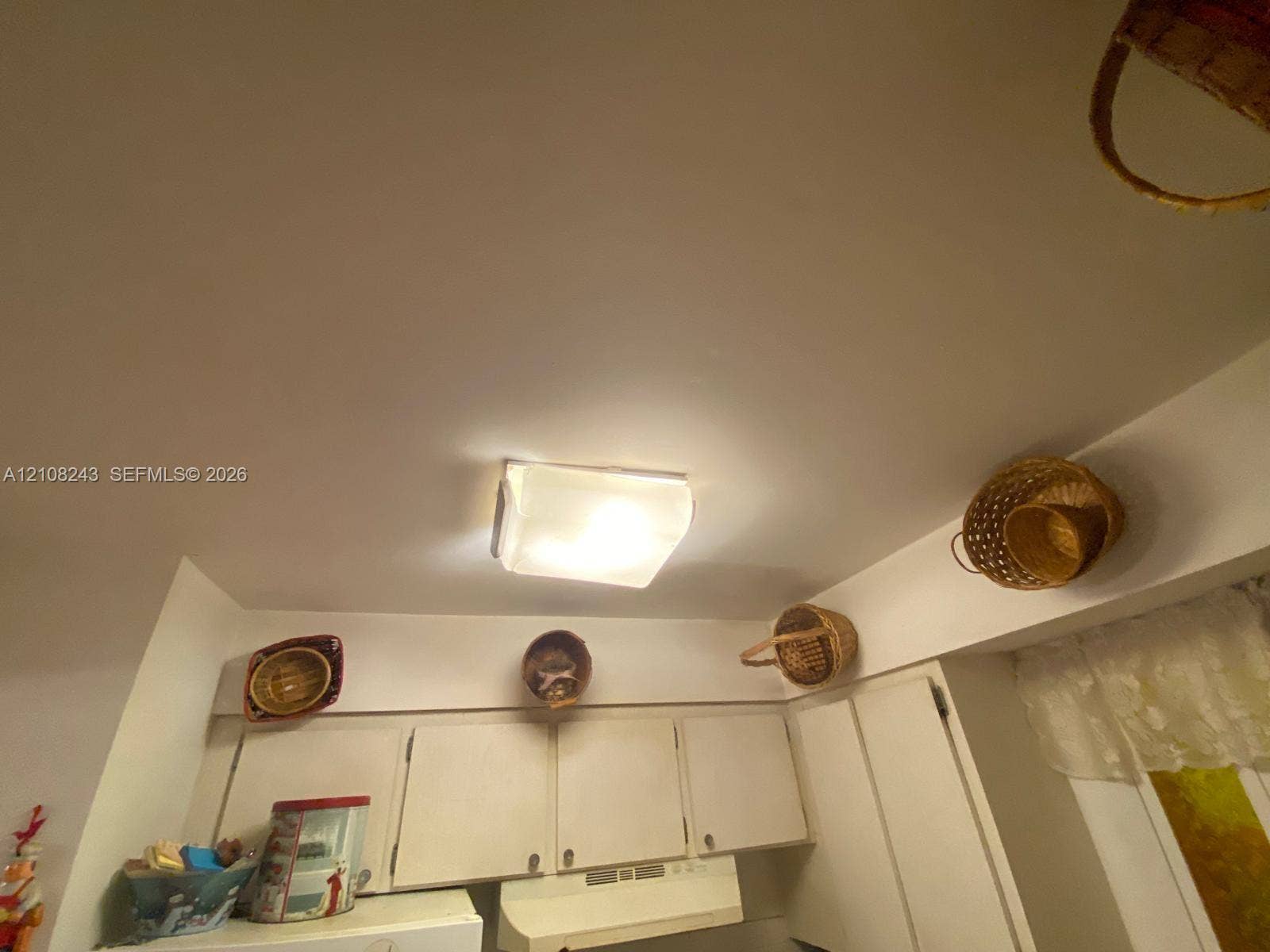 6505 Winfield Boulevard, #B-16, Margate, FL 33063 Square flush-mount ceiling light fixture with an opaque glass shade, paired with white solid-panel upper cabinetry and a matching range hood