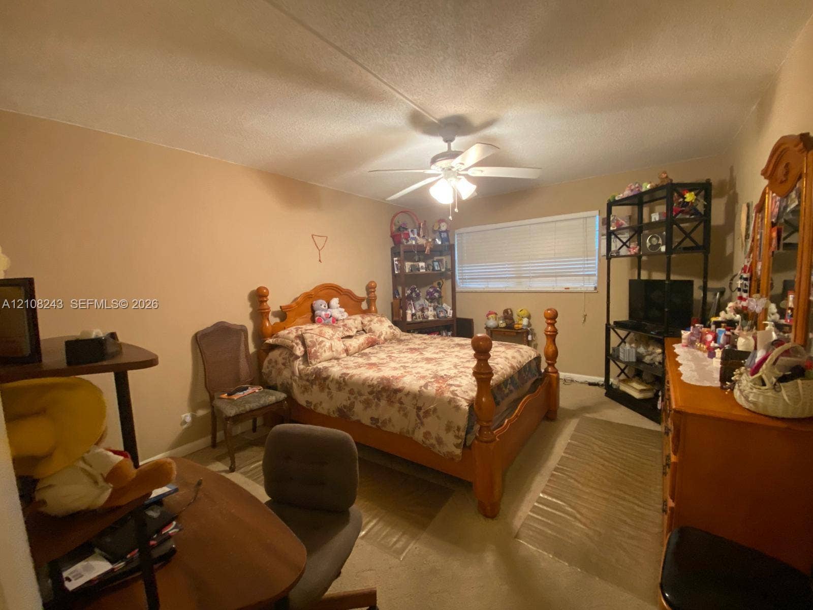 6505 Winfield Boulevard, #B-16, Margate, FL 33063 Neutral-toned interior space featuring a ceiling fan with integrated light fixture and a horizontal window with blinds
