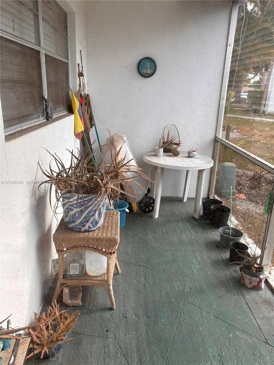 6505 Winfield Boulevard, #B-16, Margate, FL 33063 Screened-in porch featuring painted concrete flooring and aluminum-framed screening