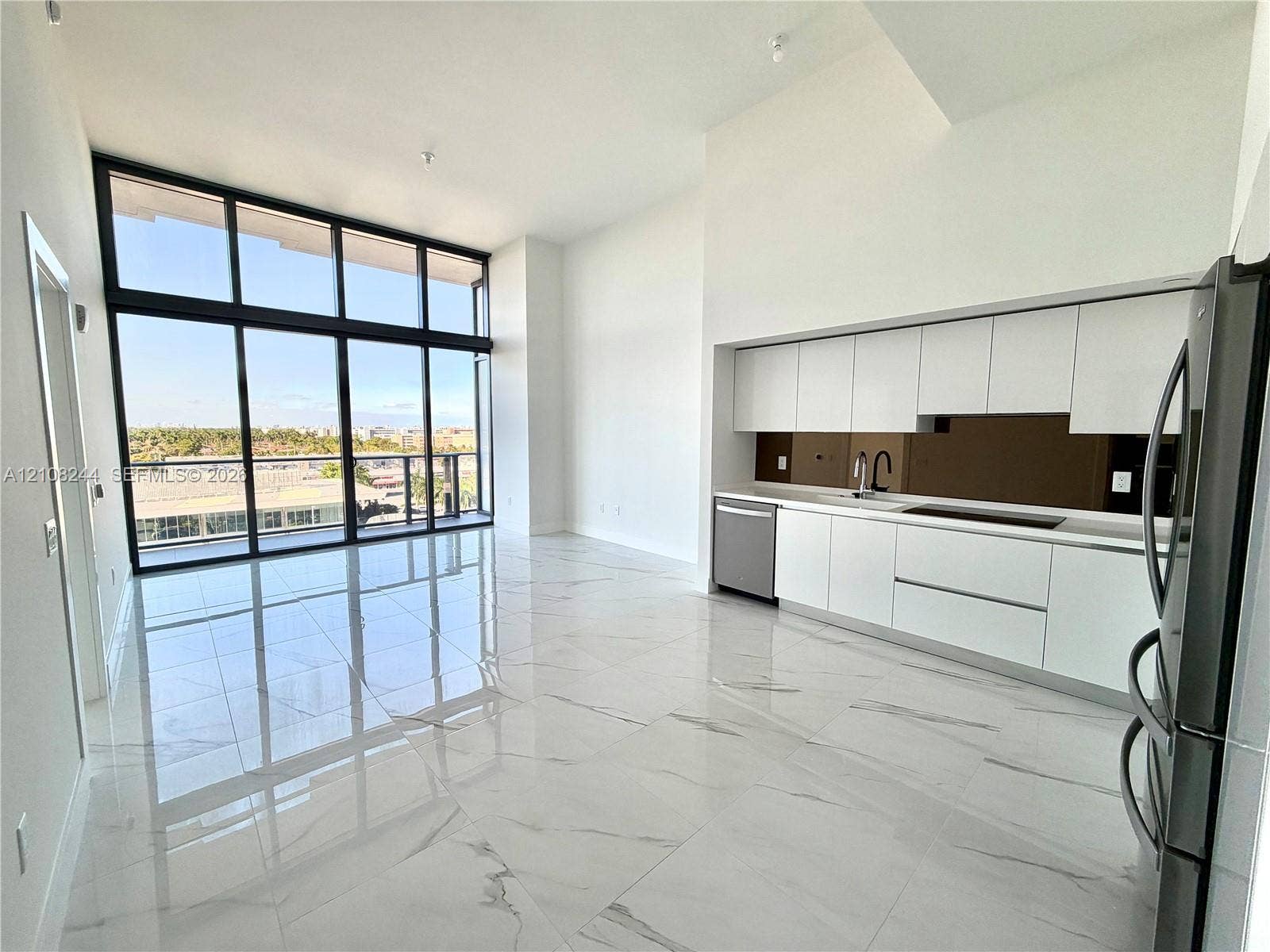 1170 Hallandale Beach Boulevard, #605, Hallandale Beach, Hallandale Beach, FL 33009 Floor-to-ceiling windows, high-gloss tile flooring, flat-panel cabinetry, and a built-in floating media console