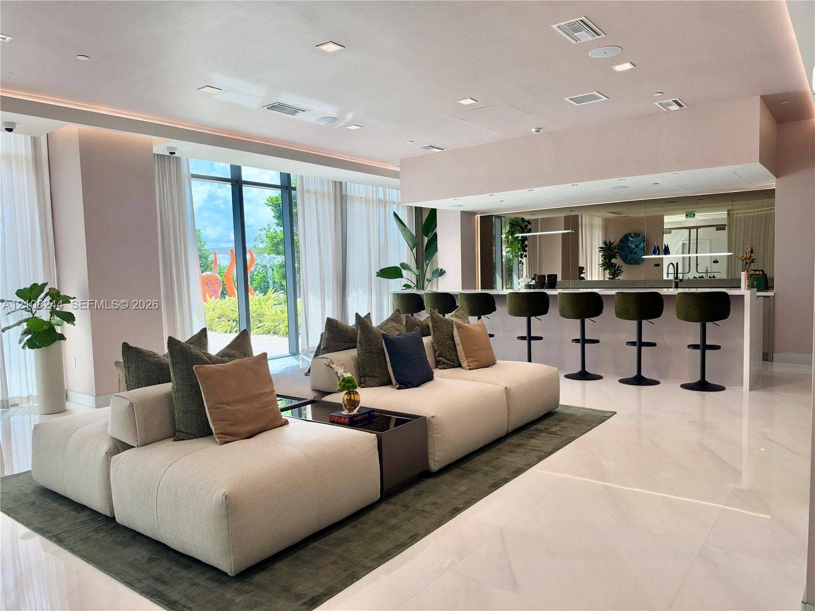1170 Hallandale Beach Boulevard, #605, Hallandale Beach, Hallandale Beach, FL 33009 Rooftop terrace featuring a large media screen, artificial turf lawn, manicured privacy hedges, mature palm trees, and an expansive pool