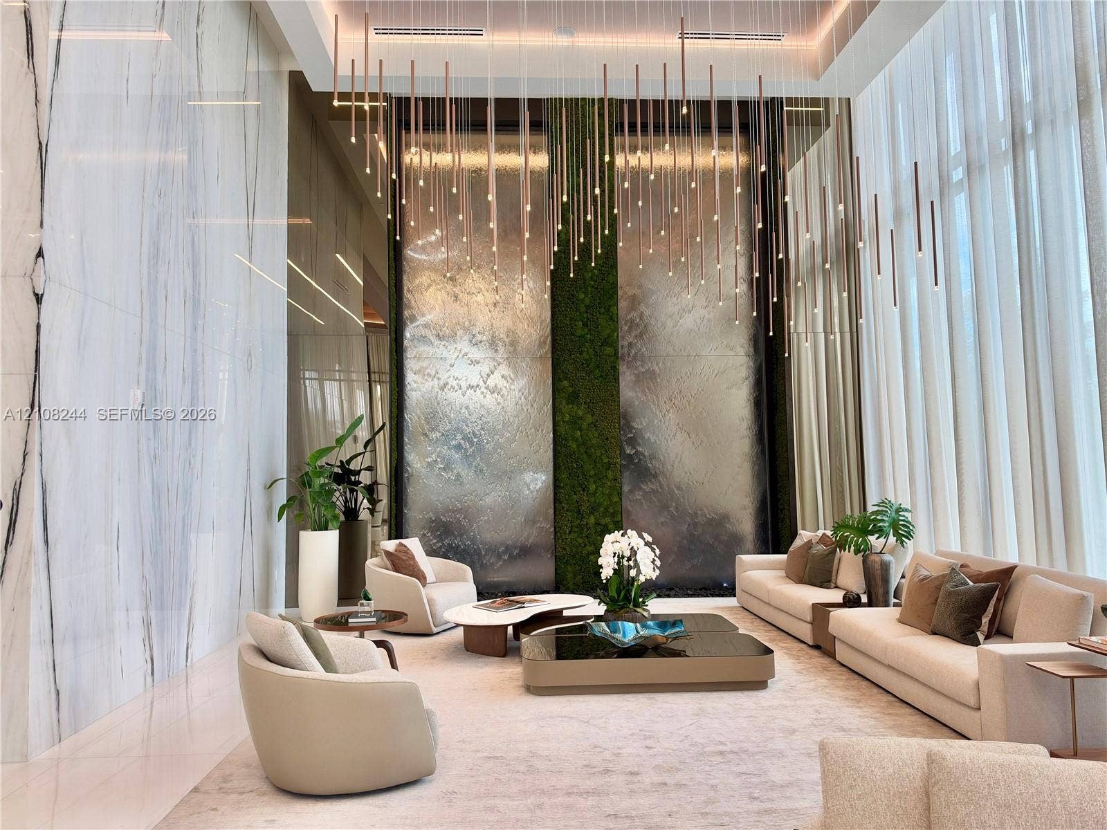 1170 Hallandale Beach Boulevard, #605, Hallandale Beach, Hallandale Beach, FL 33009 Double-height ceilings featuring floor-to-ceiling glass windows, polished stone flooring, and mirrored architectural columns