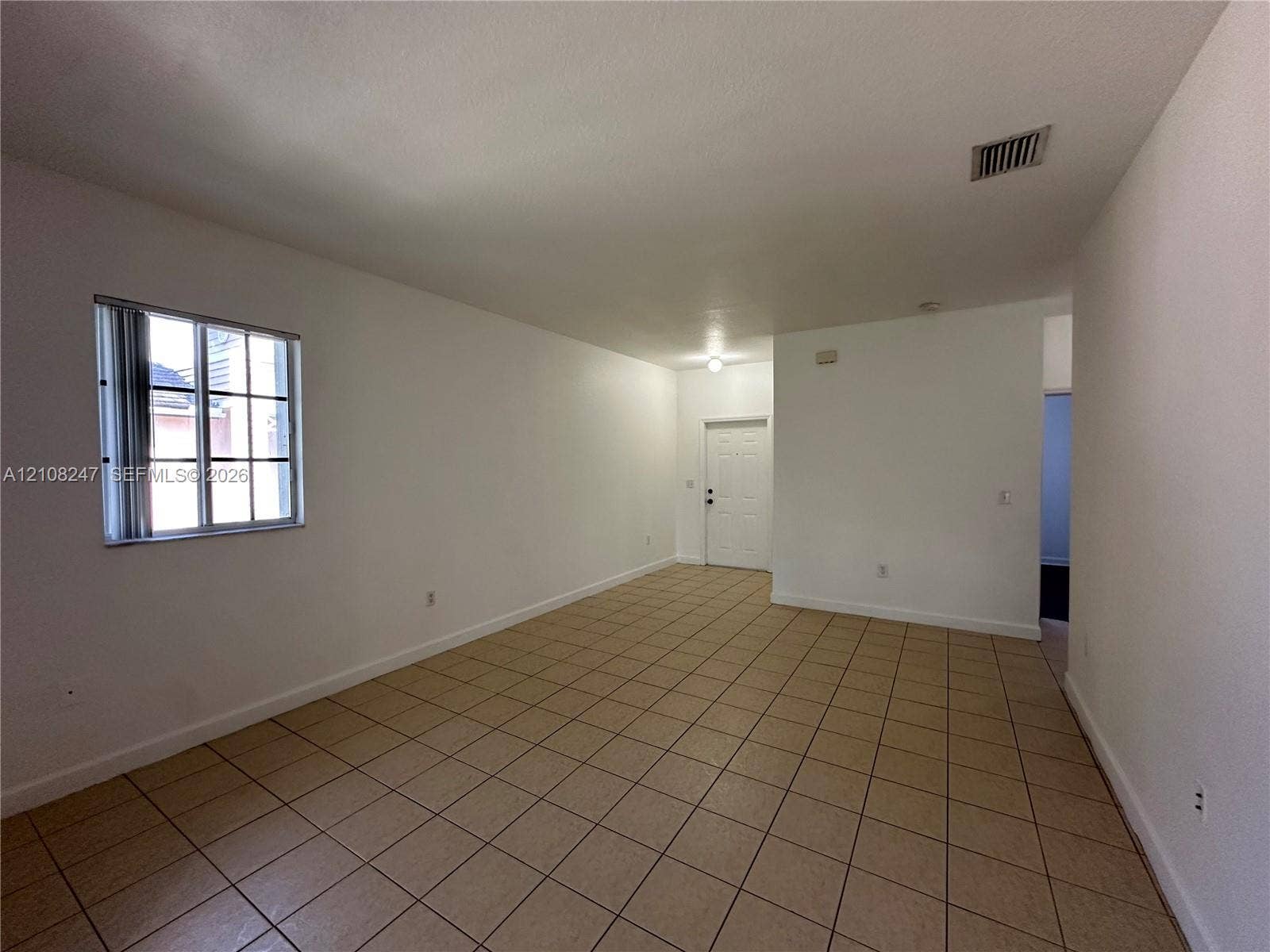 2641 NE 4th Street, #204, Homestead, Homestead, FL 33033 Interior area featuring tile flooring, neutral wall paint, and a grid-pane window