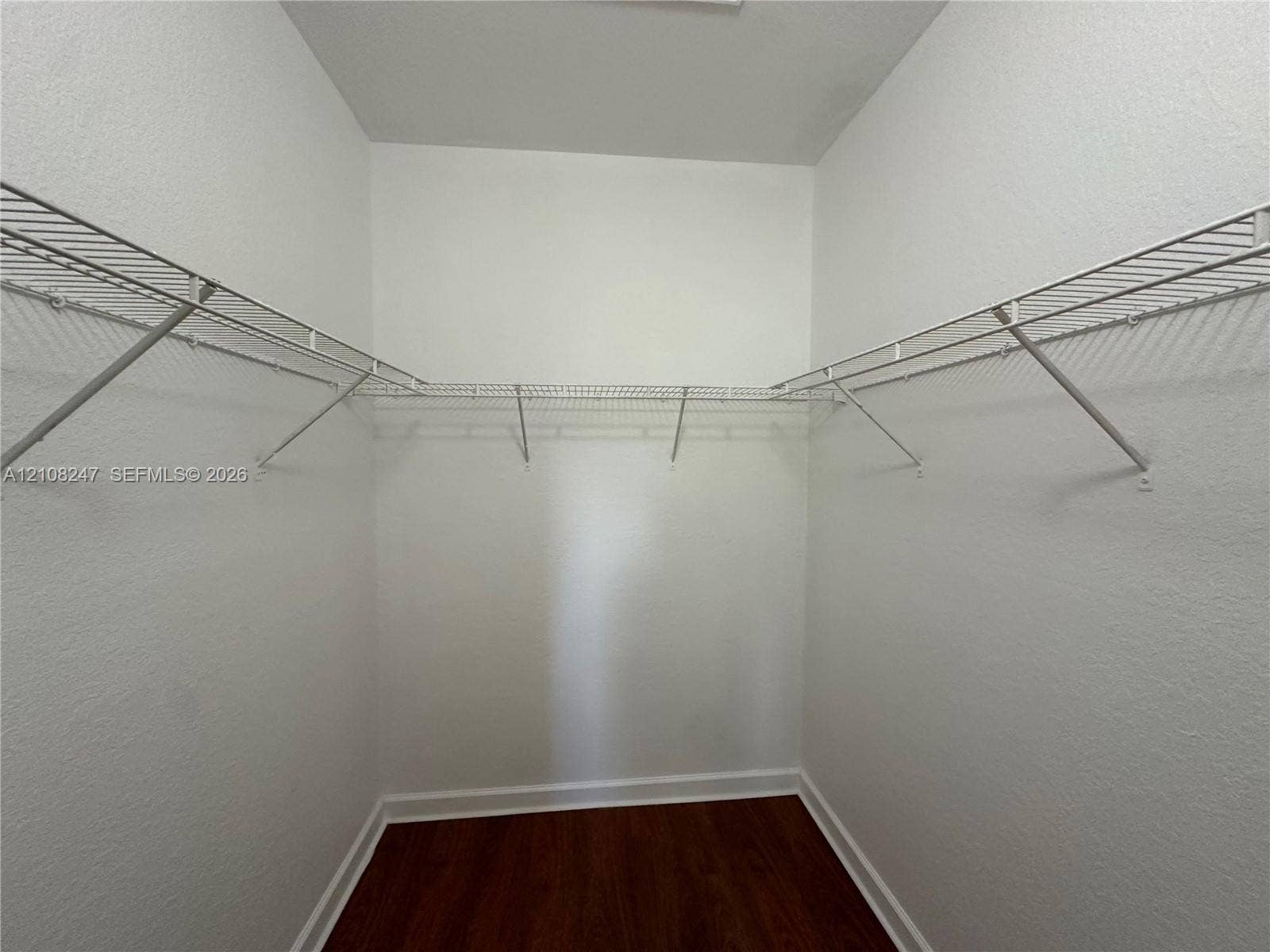 2641 NE 4th Street, #204, Homestead, Homestead, FL 33033 Storage space featuring white wire shelving and wood-finish flooring