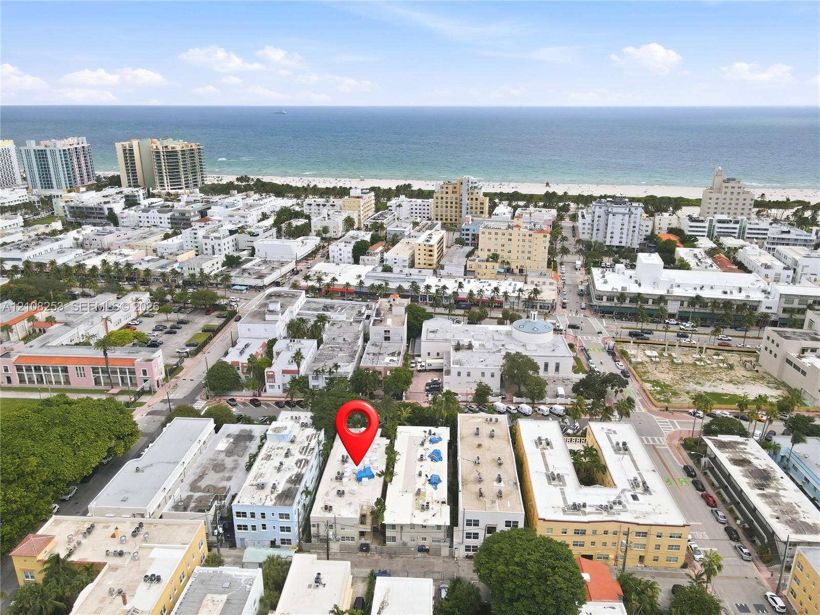 1330 Drexel Avenue, #102, Miami Beach, FL 33139 Aerial perspective featuring a multi-story urban building situated in a coastal metropolitan setting