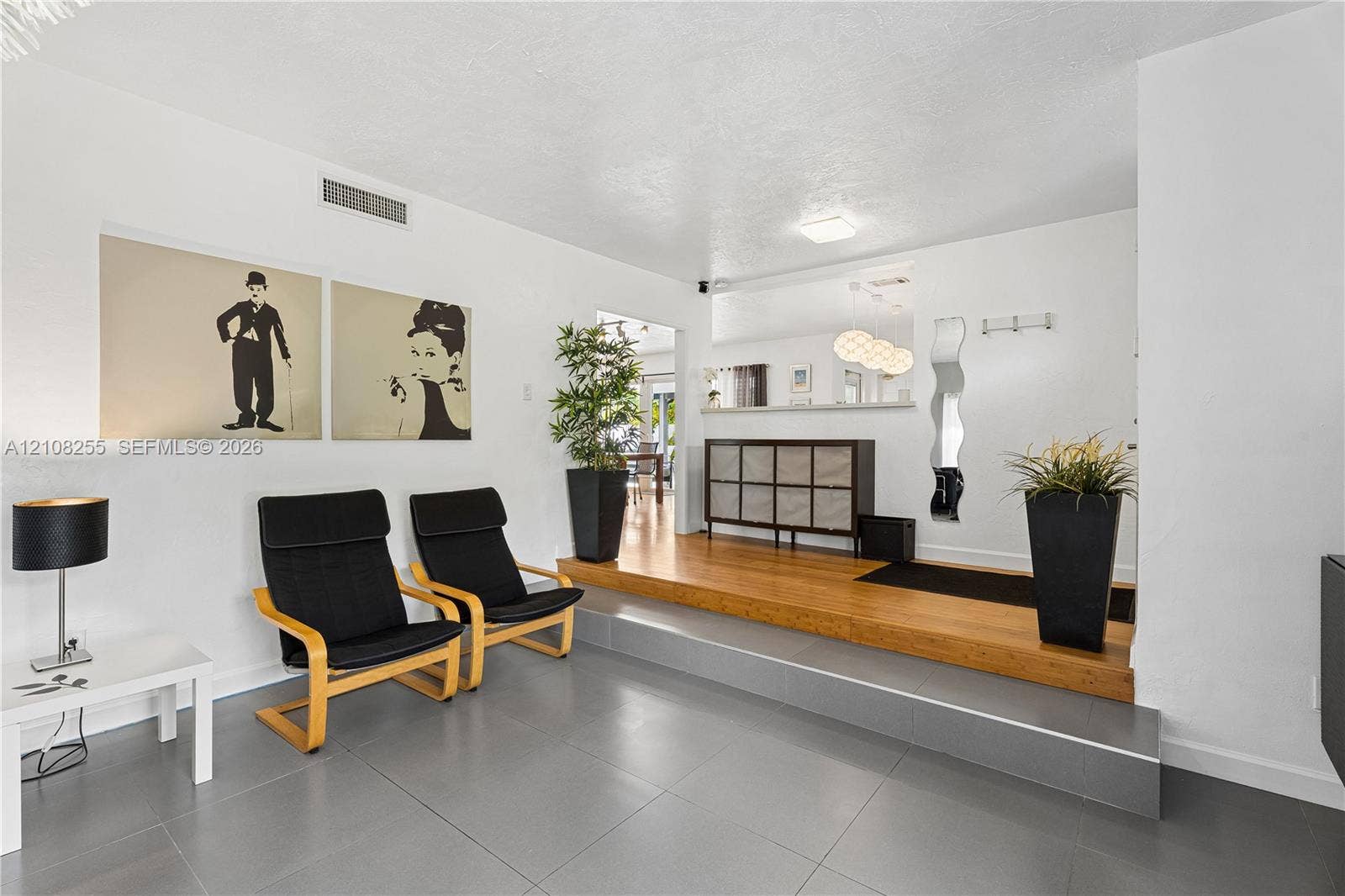 1650 NE 171st Street, North Miami Beach, North Miami Beach, FL 33162 Multi-level flooring featuring large-format grey tile and raised wood-finish platform