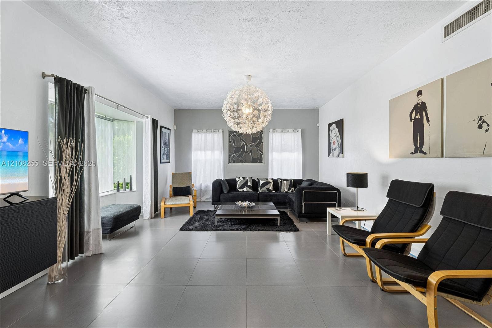 1650 NE 171st Street, North Miami Beach, North Miami Beach, FL 33162 Large-format tile flooring, oversized bay window, and contemporary spherical chandelier
