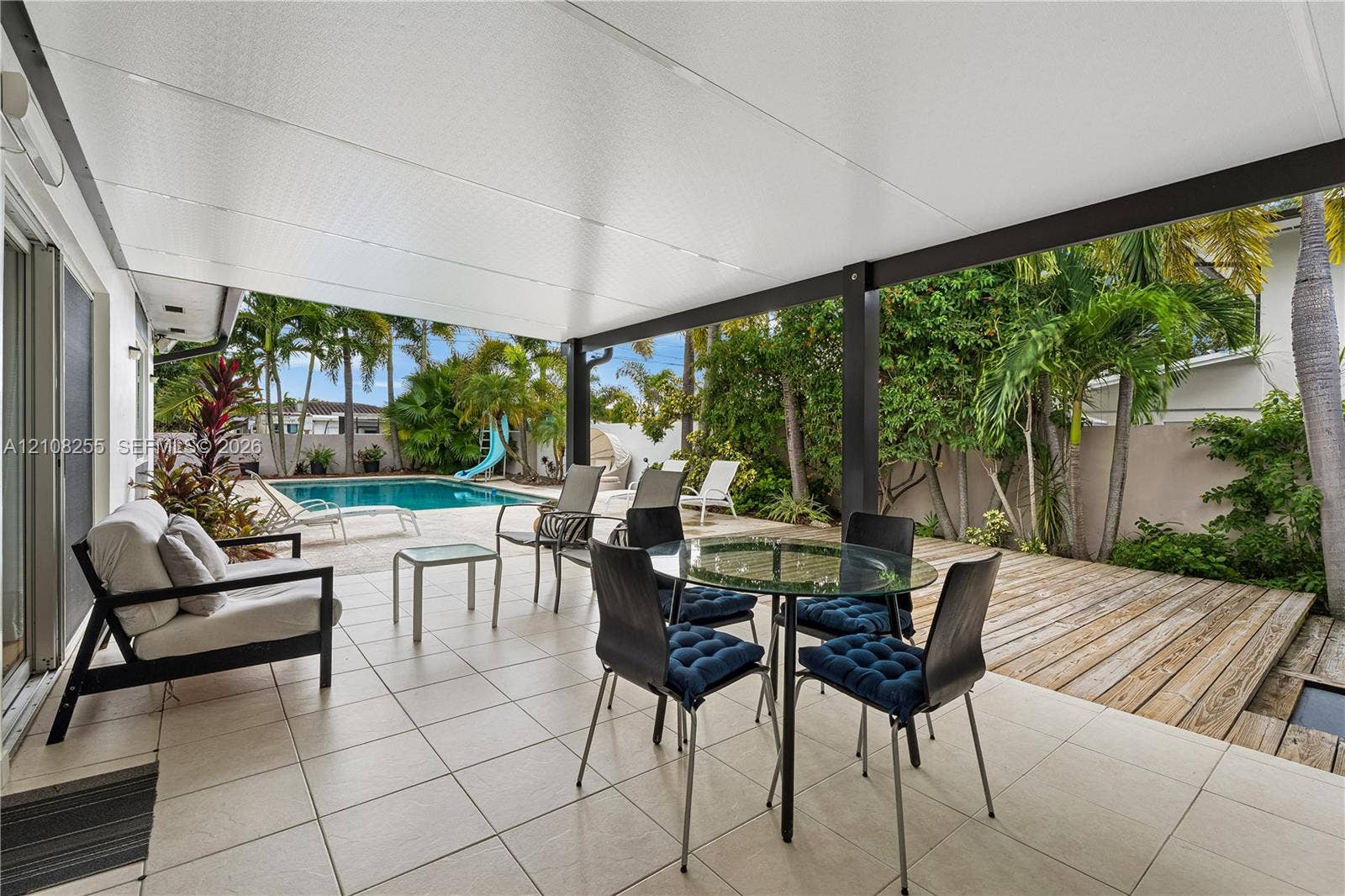 1650 NE 171st Street, North Miami Beach, North Miami Beach, FL 33162 Covered patio with neutral tile flooring, wood decking, and a swimming pool