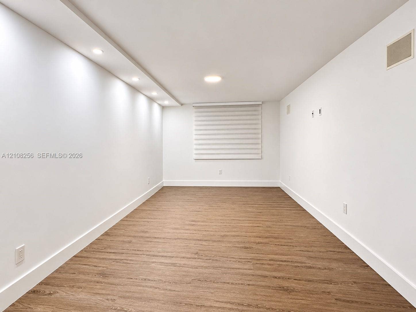 9350 Fontainebleau Boulevard, #110, Miami, Miami, FL 33172 Wood-finish flooring, recessed lighting, integrated ceiling cove lighting, and window with white roller shade