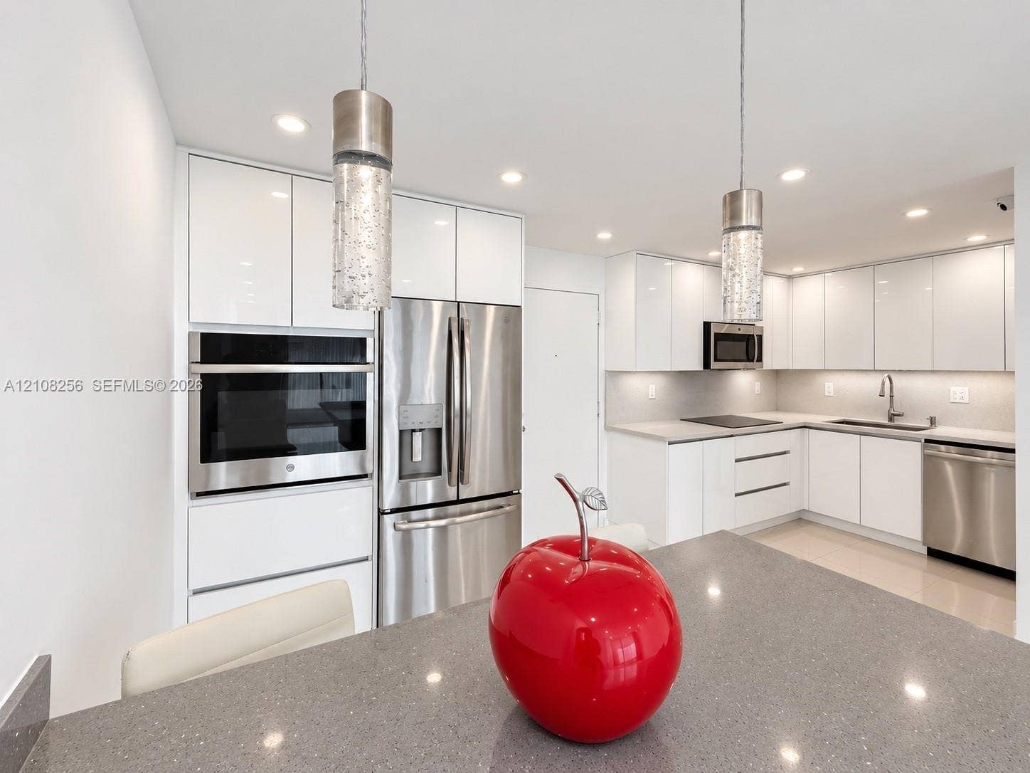9350 Fontainebleau Boulevard, #110, Miami, Miami, FL 33172 Kitchen featuring high-gloss white cabinetry, stainless steel appliances, quartz countertops, recessed lighting, and modern cylindrical pendant light fixtures