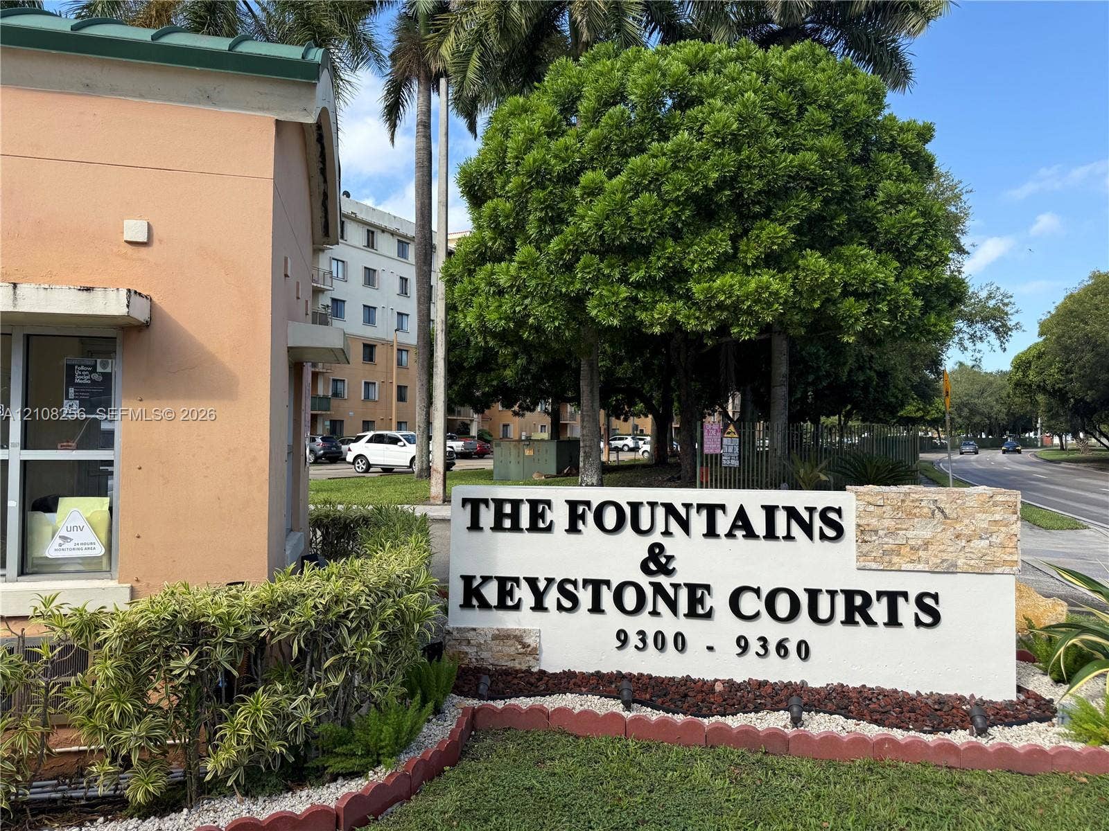 9350 Fontainebleau Boulevard, #110, Miami, Miami, FL 33172 Monument-style stone and stucco signage featuring dimensional lettering, surrounded by manicured landscaping and mature trees