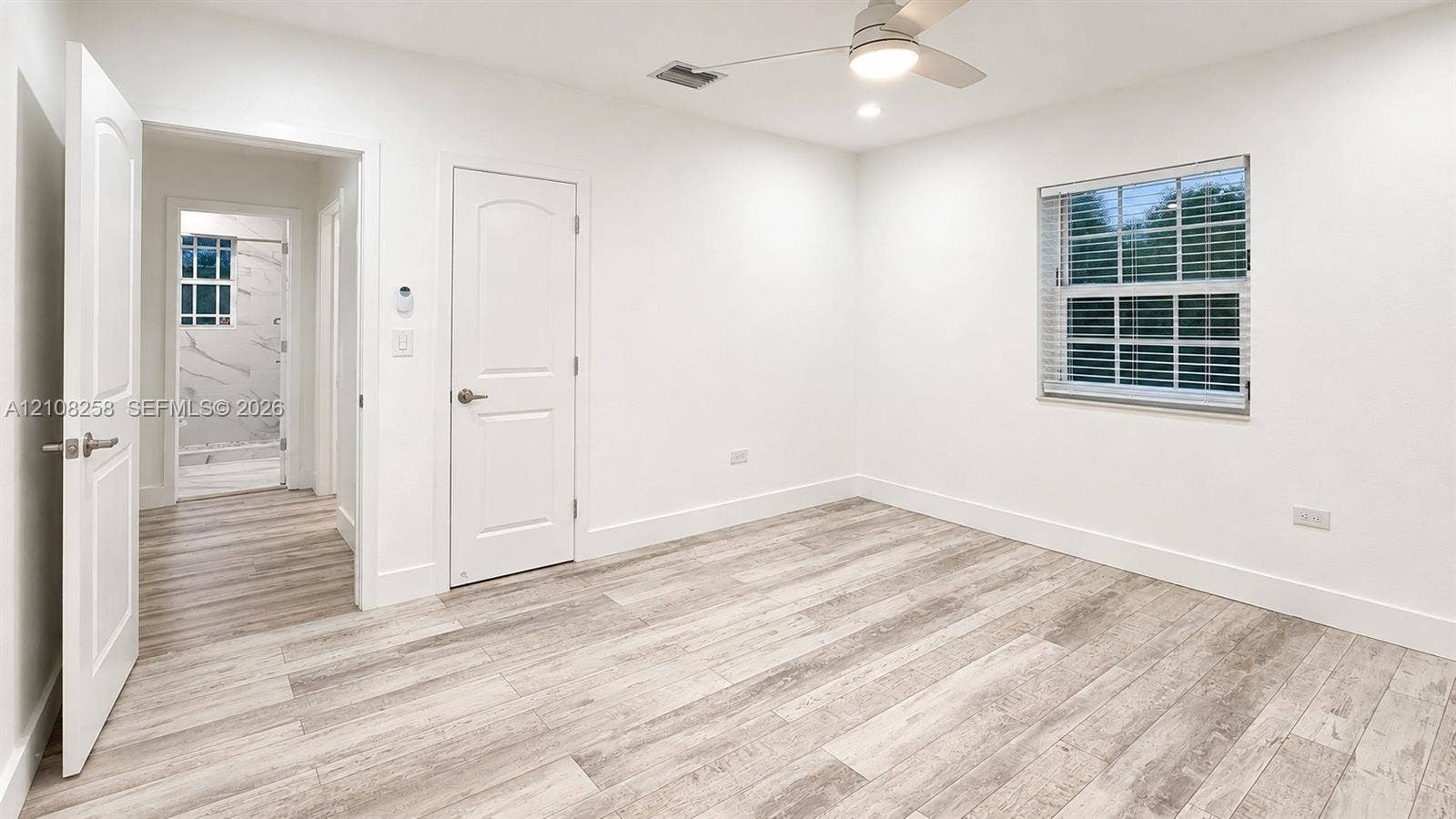 909 NE 111th Street, #909, Biscayne Park, Biscayne Park, FL 33161 Room featuring wood-finish flooring, recessed lighting, a ceiling fan, and multi-pane window