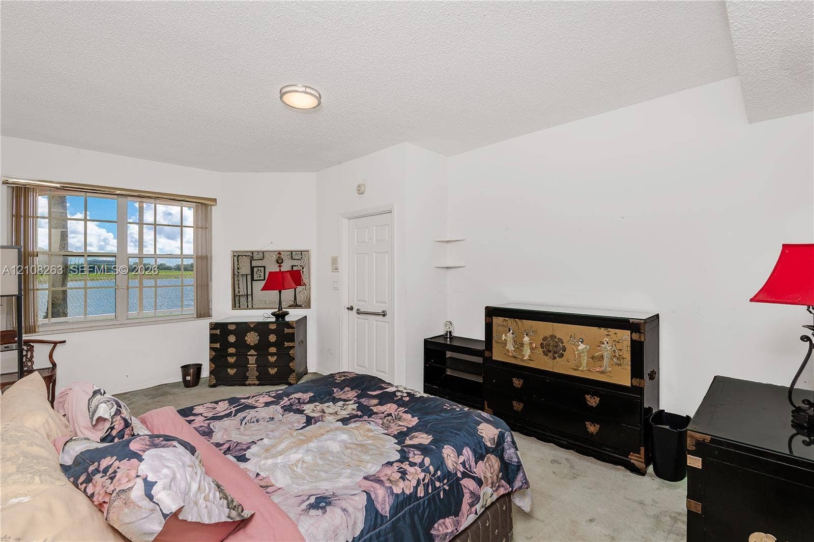 14817 Balgowan Road, #102-5, Miami Lakes, FL 33016 Multi-pane window with water backdrop, built-in shelving, and flush-mount ceiling lighting