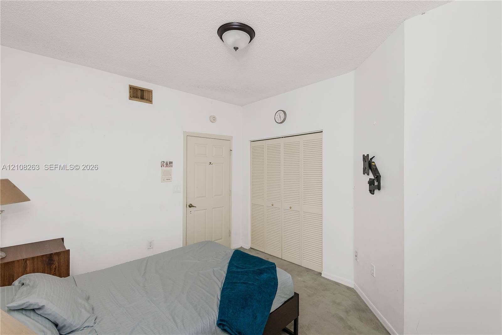 14817 Balgowan Road, #102-5, Miami Lakes, FL 33016 Interior room featuring a multi-panel door, bi-fold closet doors, and a flush-mount ceiling light fixture