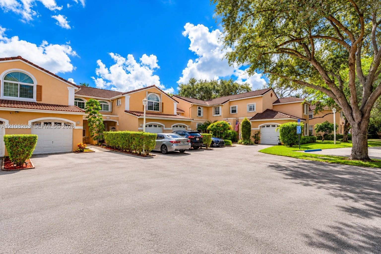 14817 Balgowan Road, #102-5, Miami Lakes, FL 33016 Stucco exterior featuring arched windows, multi-level rooflines with terracotta tiles, and attached garages