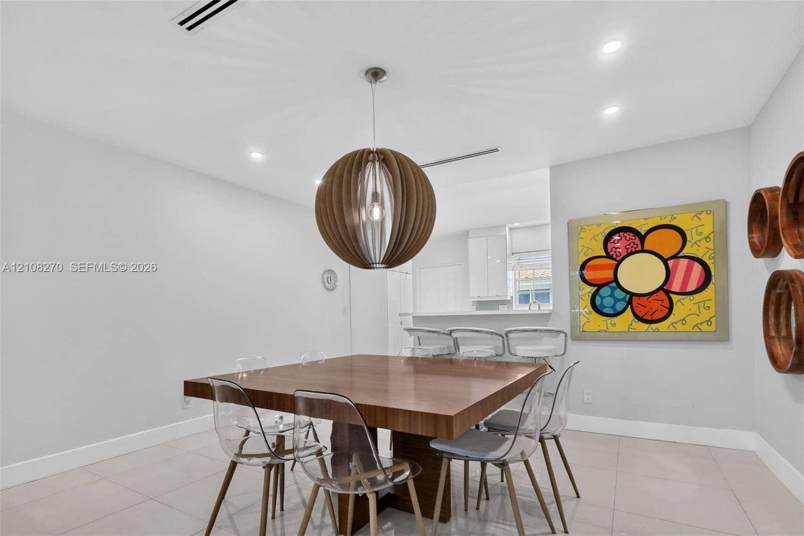 1125 99th Street, #12, Bay Harbor Islands, FL 33154 Dining area featuring large-format tile flooring, recessed ceiling lighting, and a spherical wooden pendant fixture