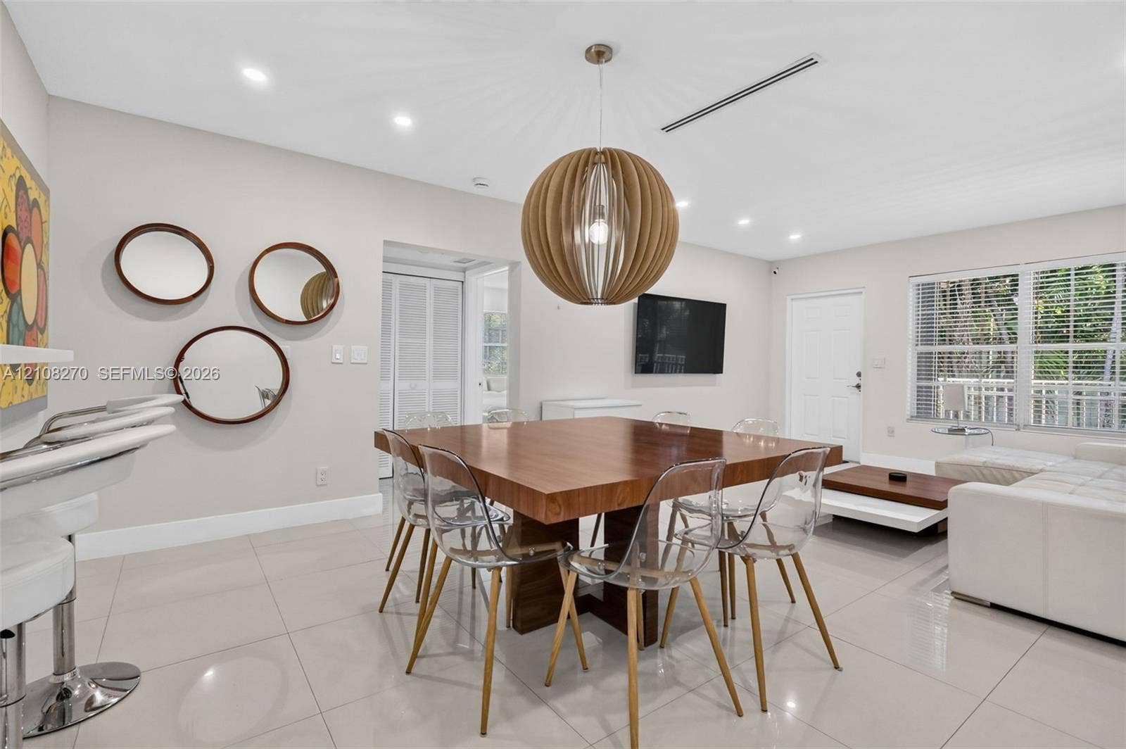 1125 99th Street, #12, Bay Harbor Islands, FL 33154 Large-format neutral floor tiling, recessed lighting, and a prominent spherical pendant light fixture