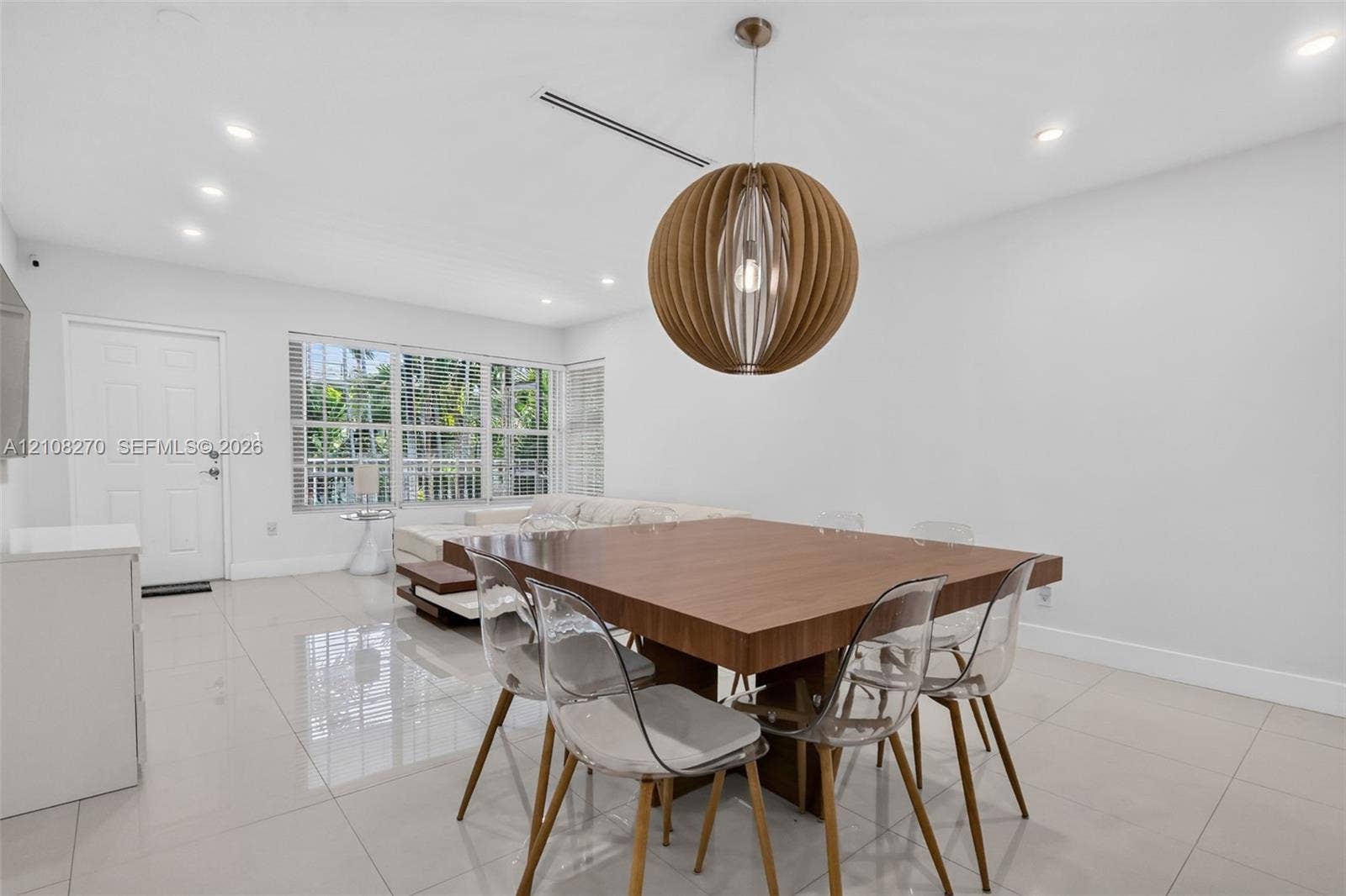 1125 99th Street, #12, Bay Harbor Islands, FL 33154 Large-format neutral tile flooring, recessed ceiling lighting, and a spherical wood-slat pendant fixture