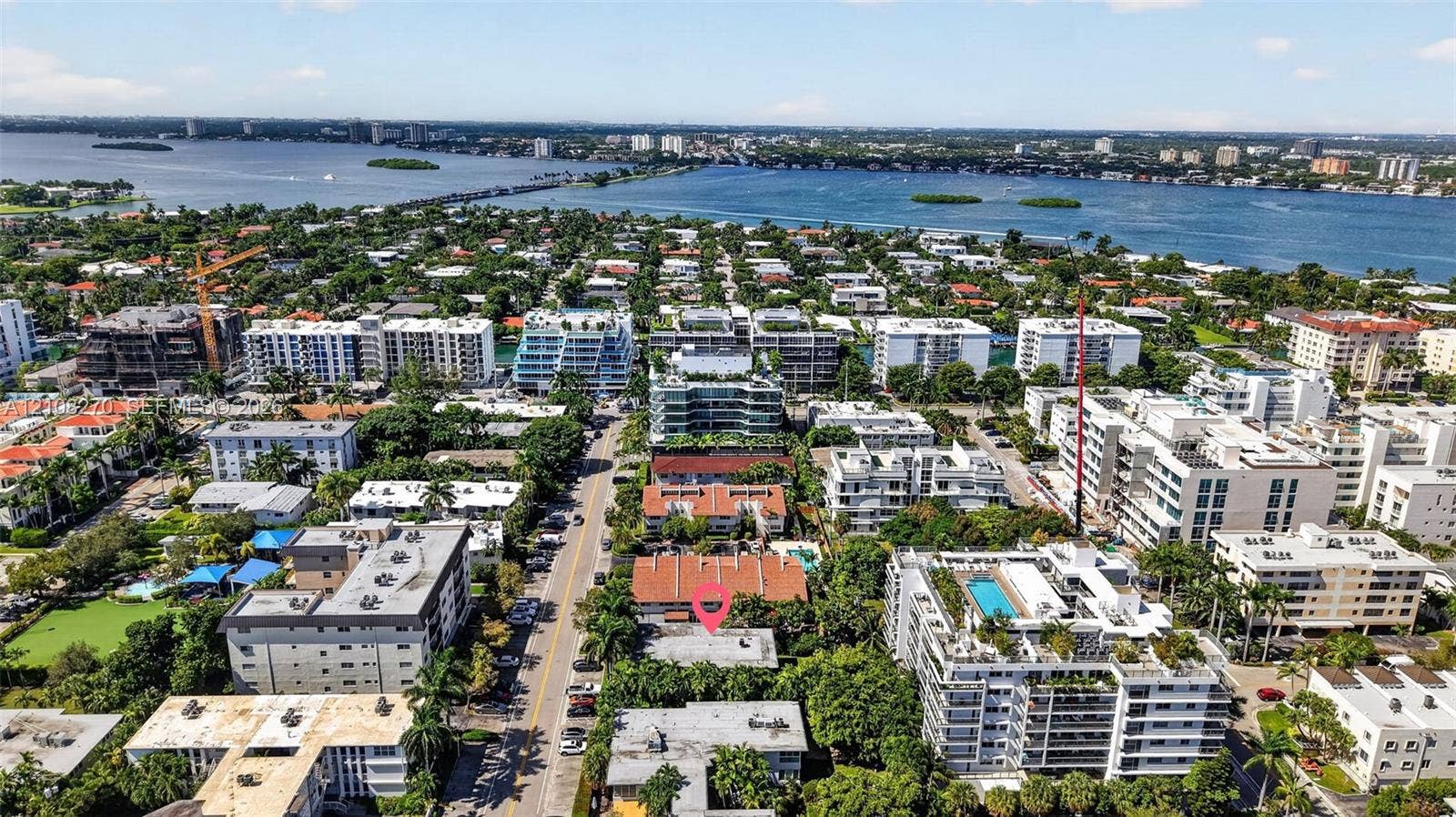 1125 99th Street, #12, Bay Harbor Islands, FL 33154 Aerial perspective featuring a property location within a dense coastal residential area, characterized by proximity to the waterfront and surrounding mature vegetation