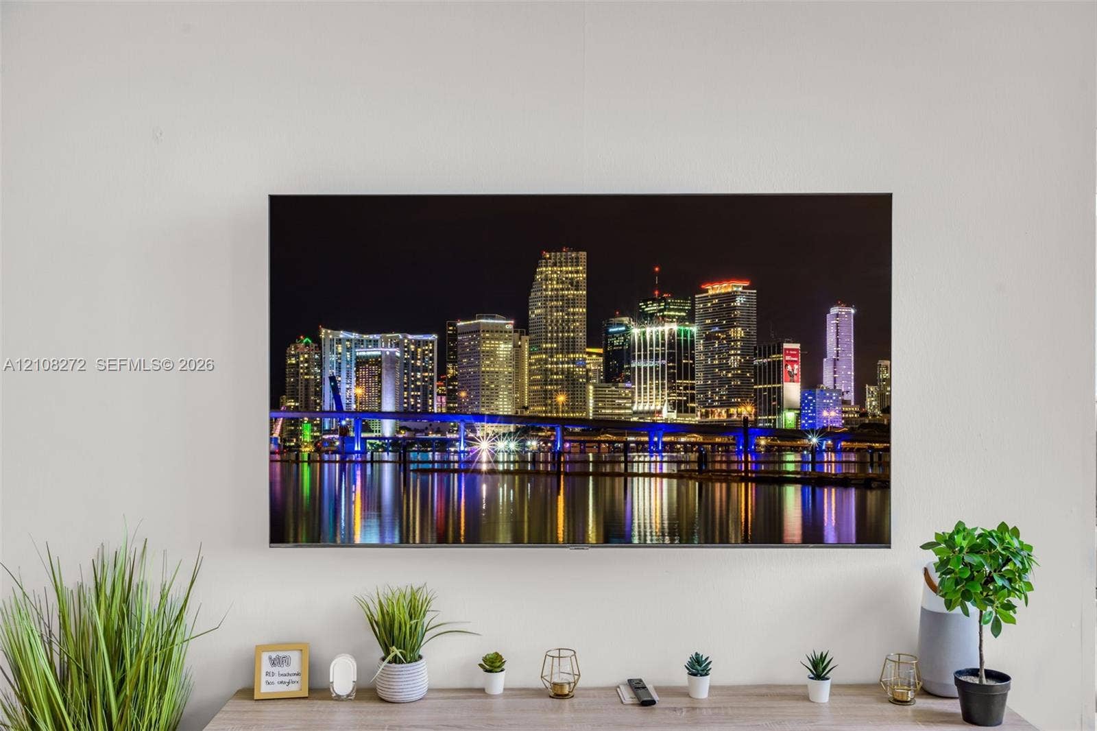 Wall-mounted flat-panel television featuring a high-resolution urban skyline display