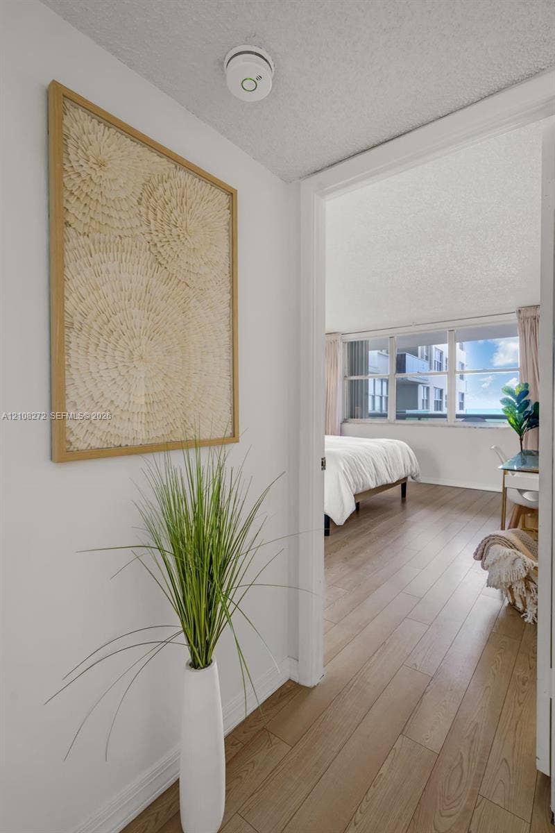Interior space featuring wood-finish flooring and large multi-pane windows