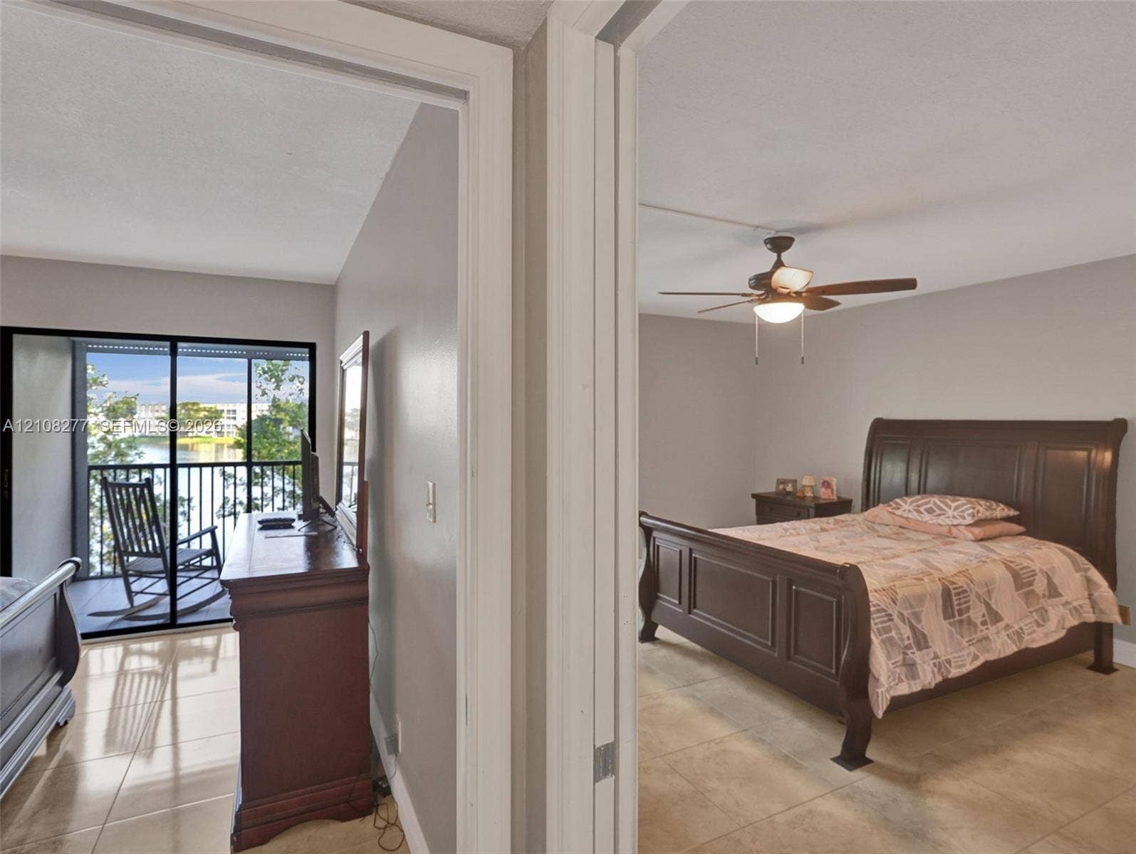 7466 Ashmont Circle, #303, Tamarac, FL 33321 Tile flooring throughout, ceiling fan with light fixture, and sliding glass door opening to a screened balcony