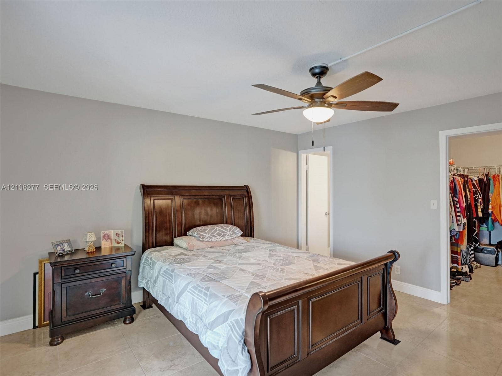 7466 Ashmont Circle, #303, Tamarac, FL 33321 Neutral interior walls, tile flooring, and a ceiling-mounted fan with integrated lighting