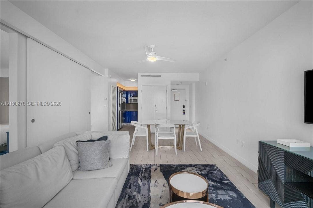 3101 Bayshore Drive, #701, Fort Lauderdale, FL 33304 Open-concept interior featuring wood-finish tile flooring, ceiling fan, and smooth-finish walls