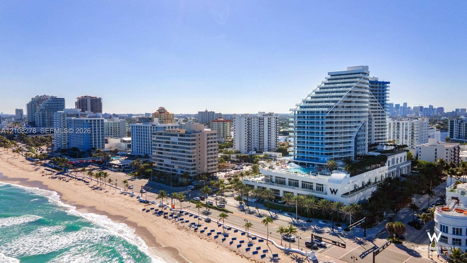 3101 Bayshore Drive, #701, Fort Lauderdale, FL 33304 Aerial perspective of a high-rise building featuring glass-balcony facades, an elevated podium pool, and a location positioned directly along the beachfront